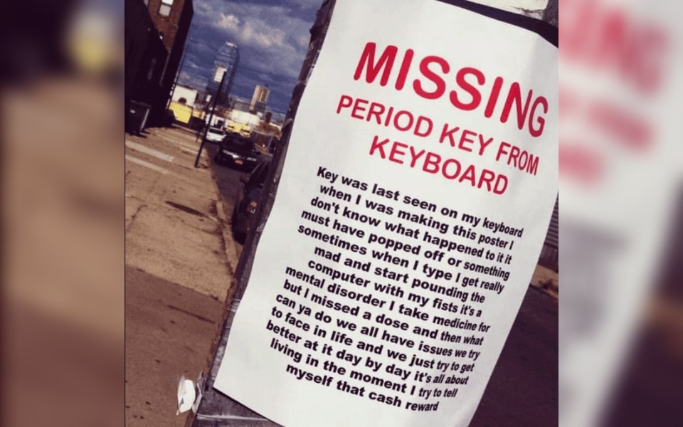 A street poster that reads "missing period key from keyboard"