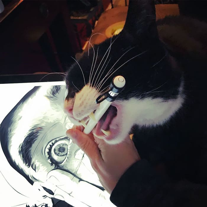 Biting on a pen while drawing