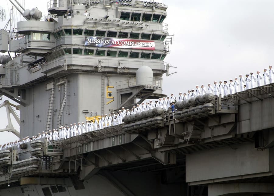 Men standing around the rails of the ship