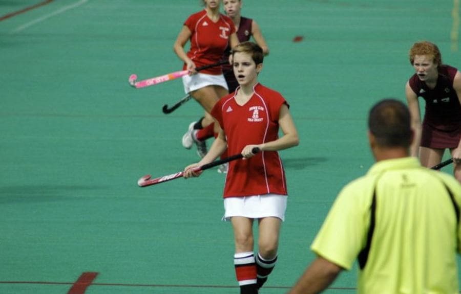 Photograph of Emma Watson playing field hockey in college.