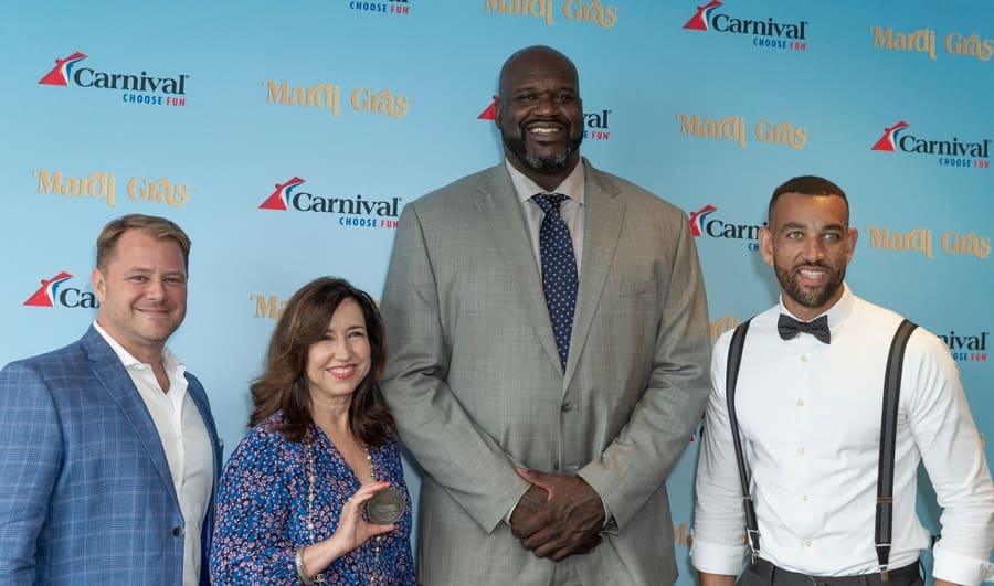 Shaq standing with Matt Mitcham, Christine Duffy, and Eddie Allen, showing you how tall he really is.
