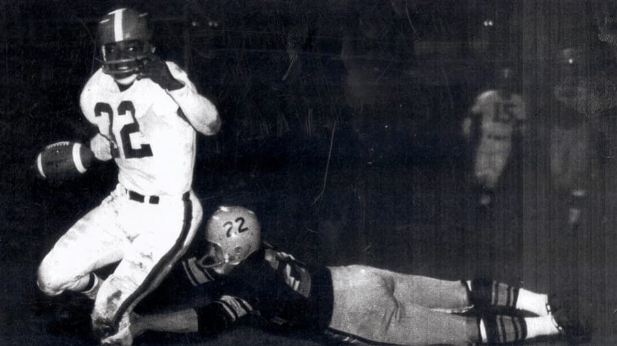 Jim Brown avoids a would-be tackler in a game against the Pittsburgh Steelers.