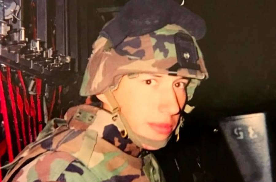Adam Driver in an army uniform and helmet. 