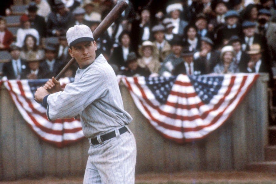Charlie Sheen in the movie Eight Men Out, holding a baseball bat standing ready to hit.
