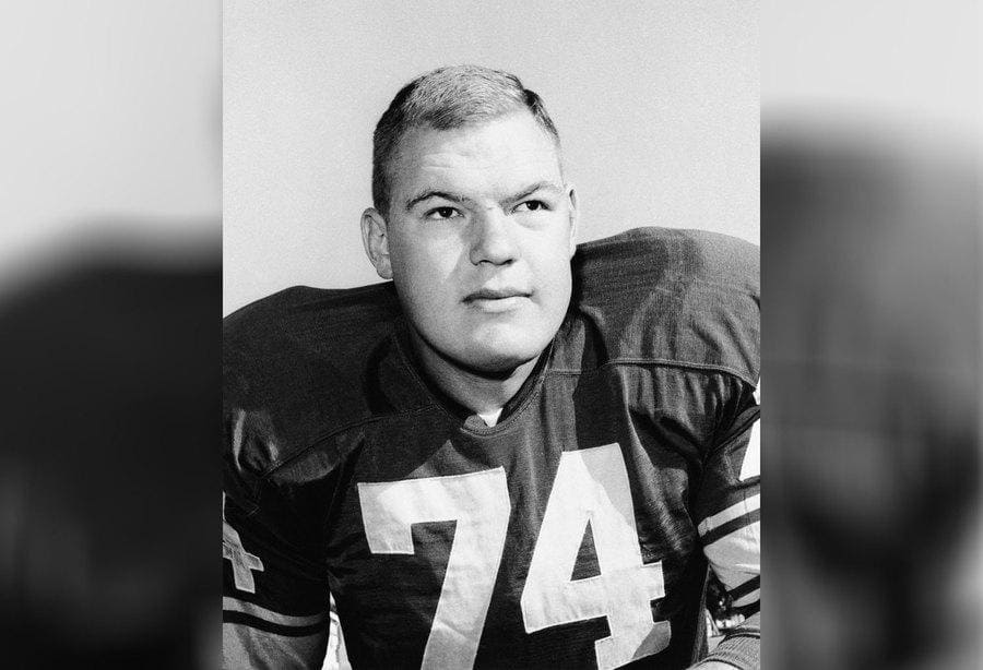 Merlin Jay Olsen posing with his uniform on with the number 74.