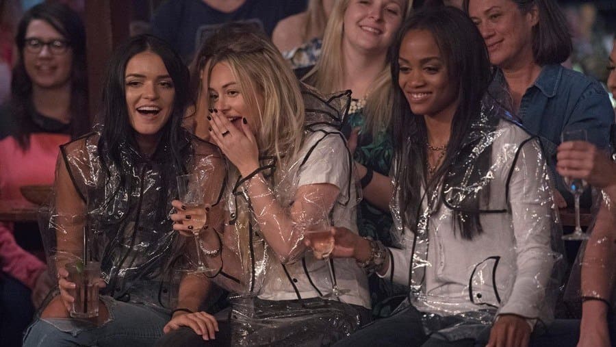 Raven, Lindsay, and Rachel sipping champagne, whispering and giggling about something going on at Men Tell All. 