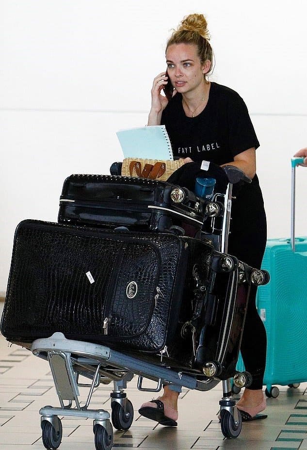 Abbie Chatfield is arriving at the airport with two large suitcases and a carry-on, rumored to be on the way to Bachelor in Paradise. 