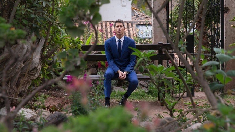 Ari on After the Final Rose sitting on a bench on the side, thinking to himself. 