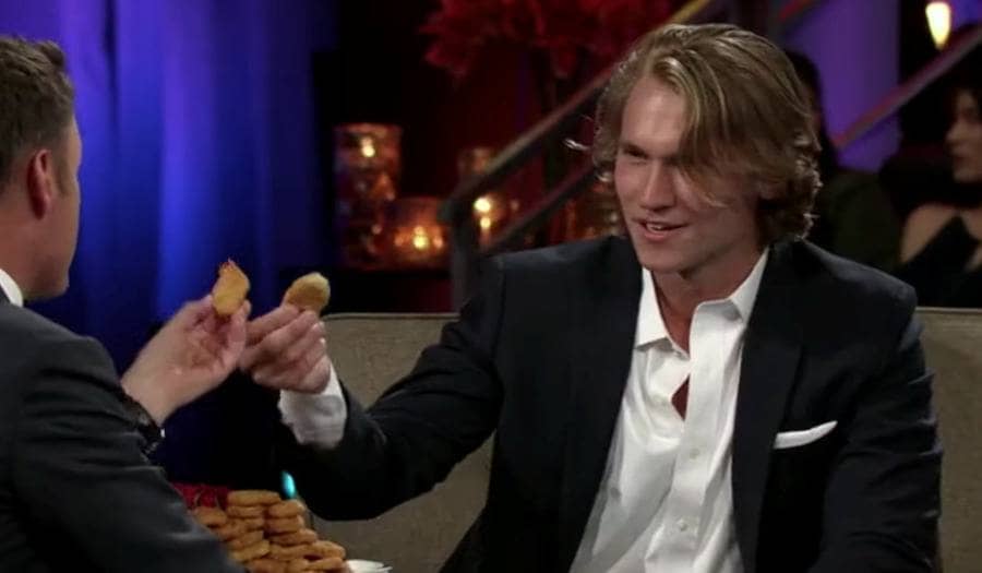 John Paul Jones was making a toast with Chris Harrison using chicken nuggets. 