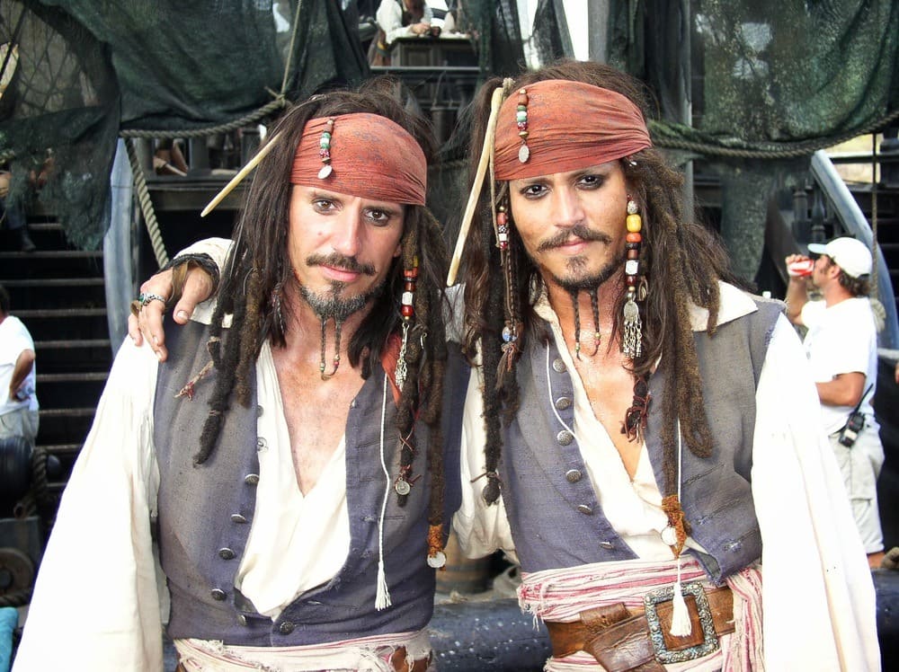 Johnny Depp and Tony Angelotti in pirate costumes on the movie set Pirates of the Caribbean.