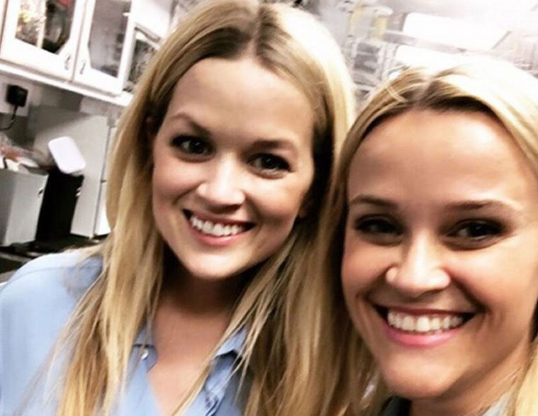 Reese Witherspoon and Marilee Lessley are wearing light blue button-down shirts.