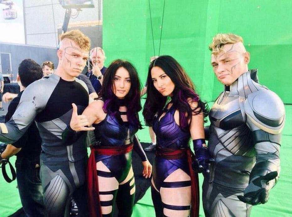 Photograph of Olivia Munn and Ben Hardy on the set of X-Men with their stunt doubles, almost looking like a mirrored photograph.