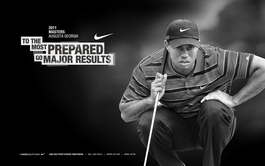 Tiger Woods in an ad for Nike kneeling on a golf course.