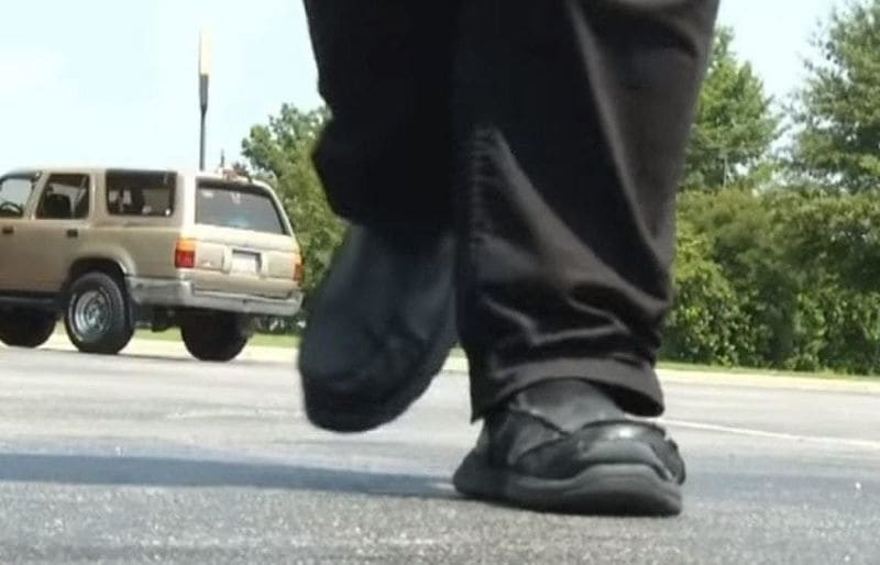 Feet walking in a parking lot