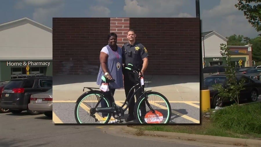 Officer Bass and Jayleysa Corbett holding a bicycle
