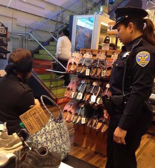 Police officer buying a homeless woman shoes