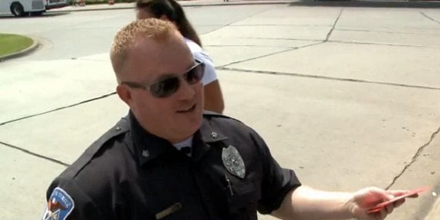 Police officer giving out gift cards