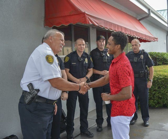 Walter Carr shaking hands with a policeman
