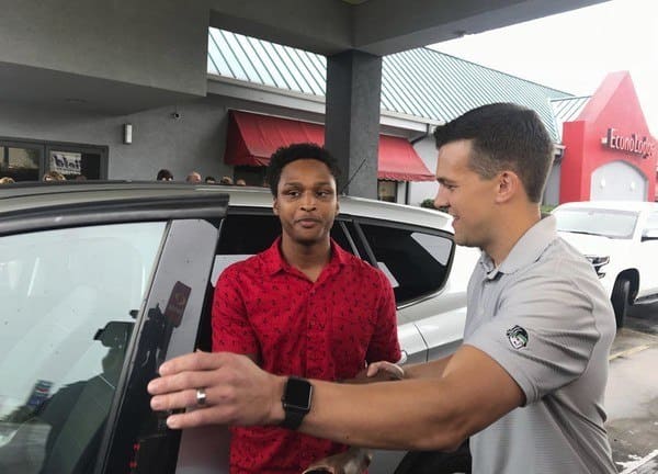 Walter Carr and Luke Marklin next to a car