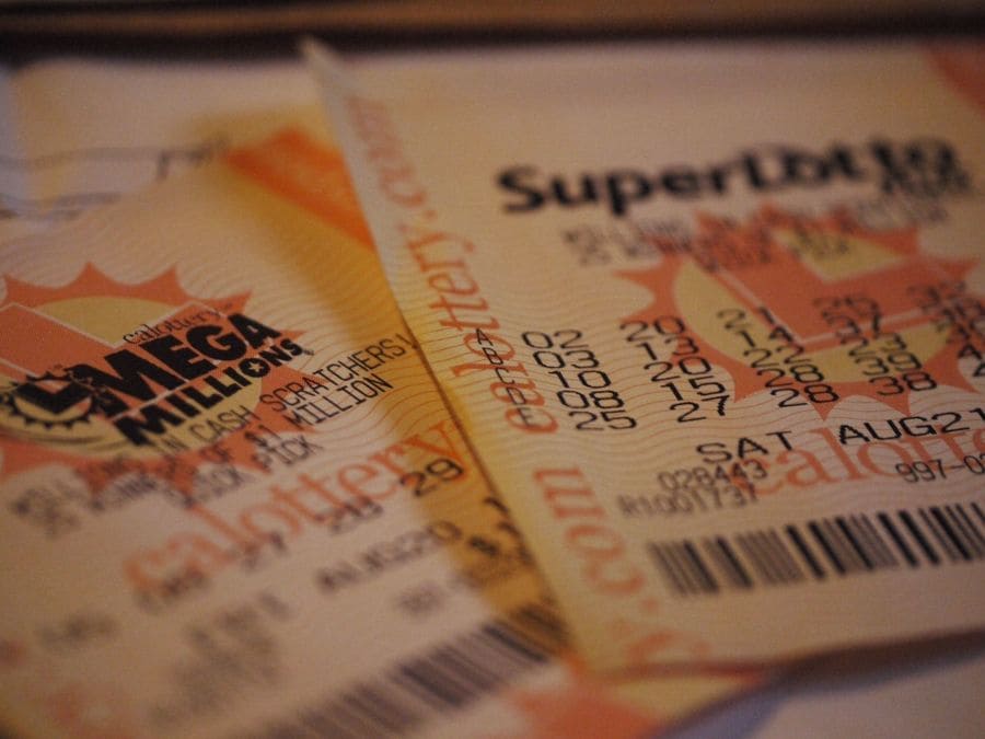 Photograph of multiple lottery tickets; one clearly shows it is a Mega Millions ticket.
