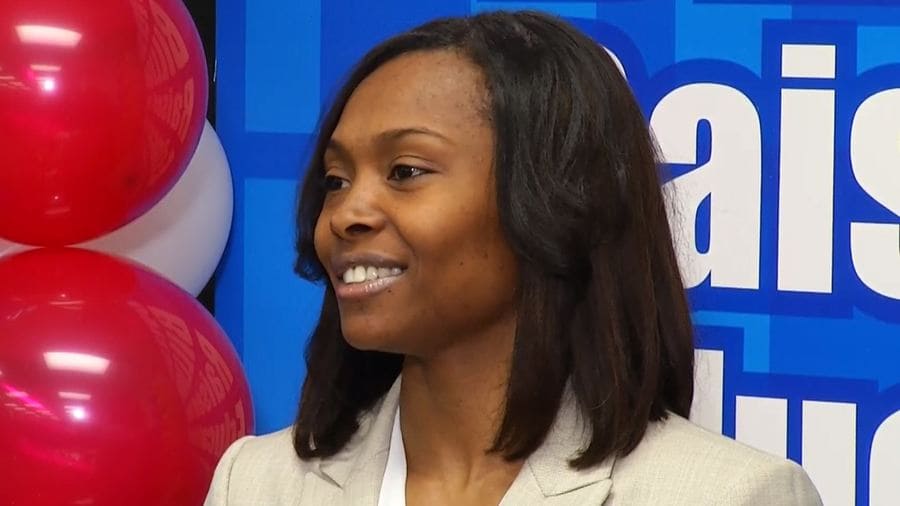 Marie Holmes photographed talking to press on the day she accepted her lottery check.