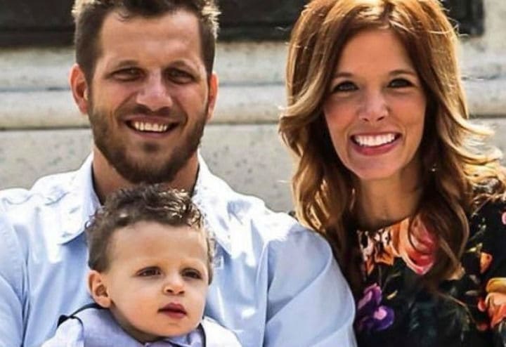 Tyler and Mandi posing for a family photo with Hunter.