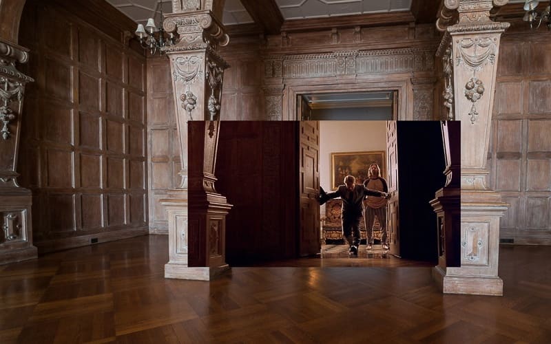 The Dude and Brandt enter the Greystone living room.