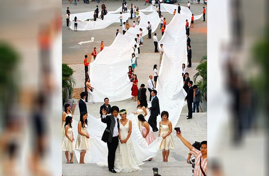 A bride wearing a dress with a long tail