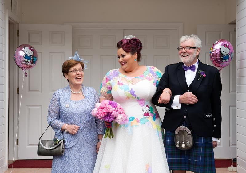 A bride wearing a Hello Kitty themed wedding dress