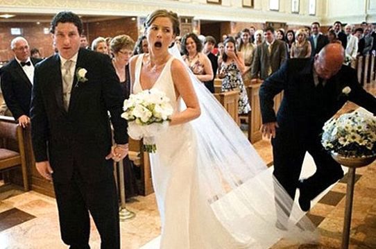 Someone stepping on a brides vail