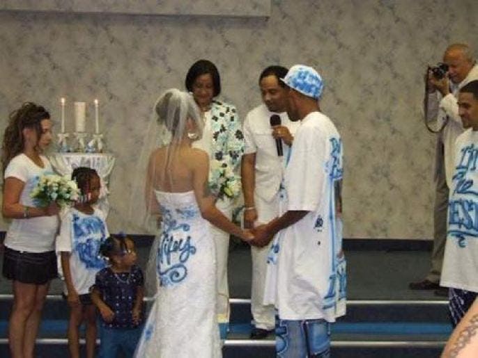 A bride and groom dressed in Graffiti at their wedding
