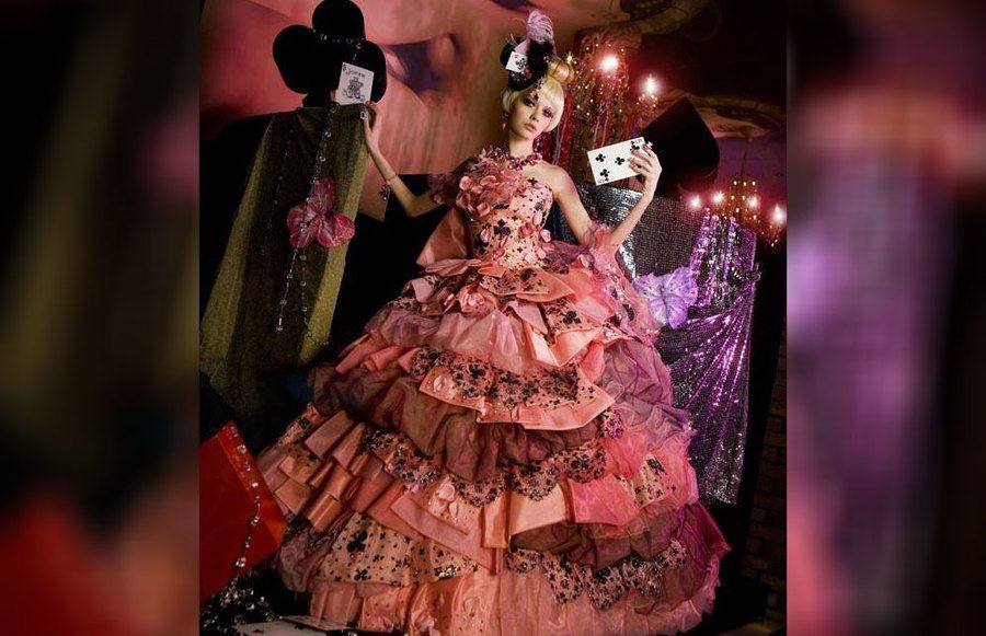 A bride wearing a queen of hearts wedding dress