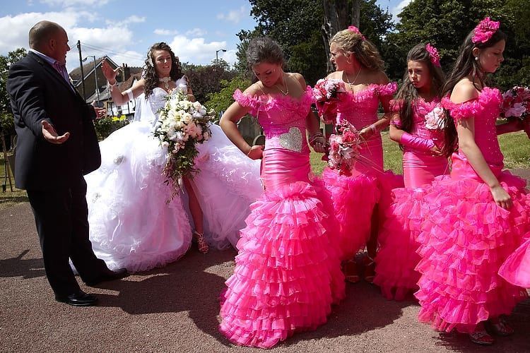 A bride and her bridesmaids dressed in hot pink