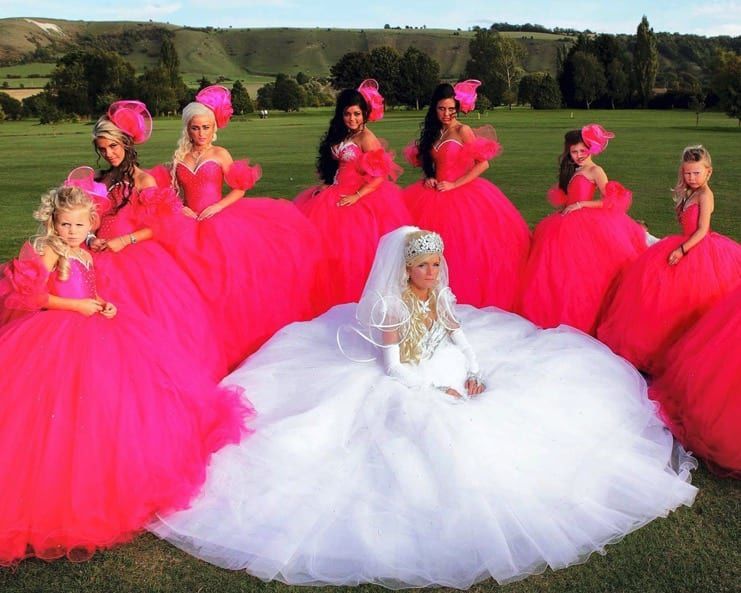 A bride wearing white and her bridesmaids in hot pink