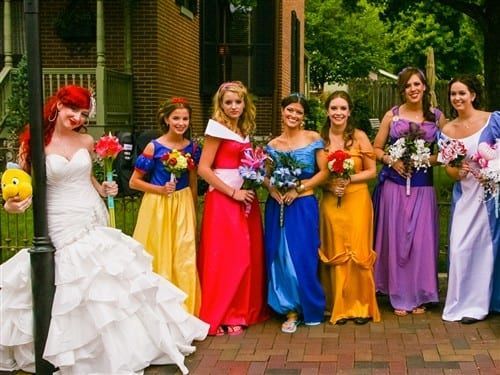 A bride and her bridesmaid dressed as Disney princesses