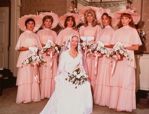 Bridesmaids wearing pink dresses and pink hats