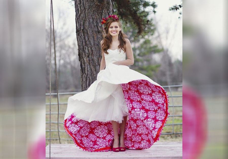 A bride with red and pink flower fabric under the dress