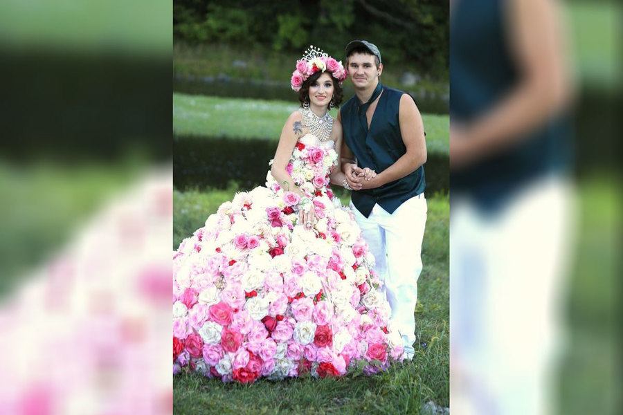 A bride wearing a wedding dress completely covered in flowers