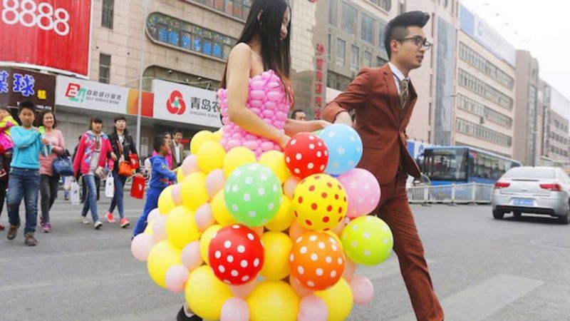 A bride wearing a dress made out of balloons