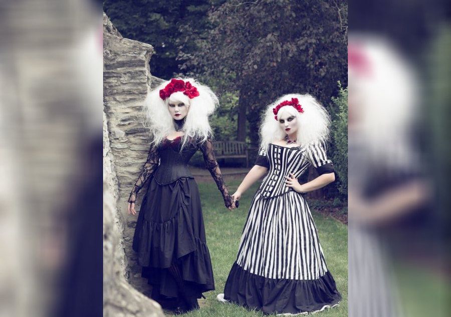 Two bridesmaids wearing gothic wedding dresses