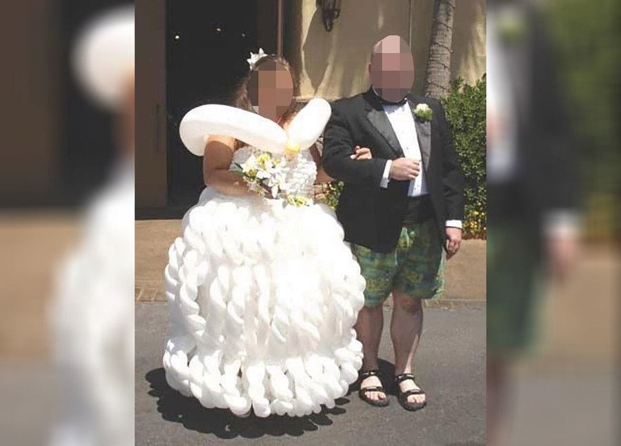 A bride wearing a weird wedding dress and a groom wearing shorts and sandals