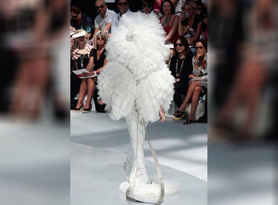 A white dress that looks like it has wings and a hat