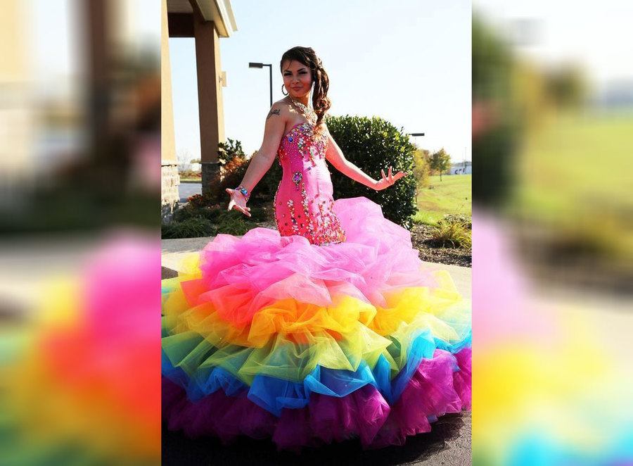 A bride wearing a pink and rainbow wedding dress