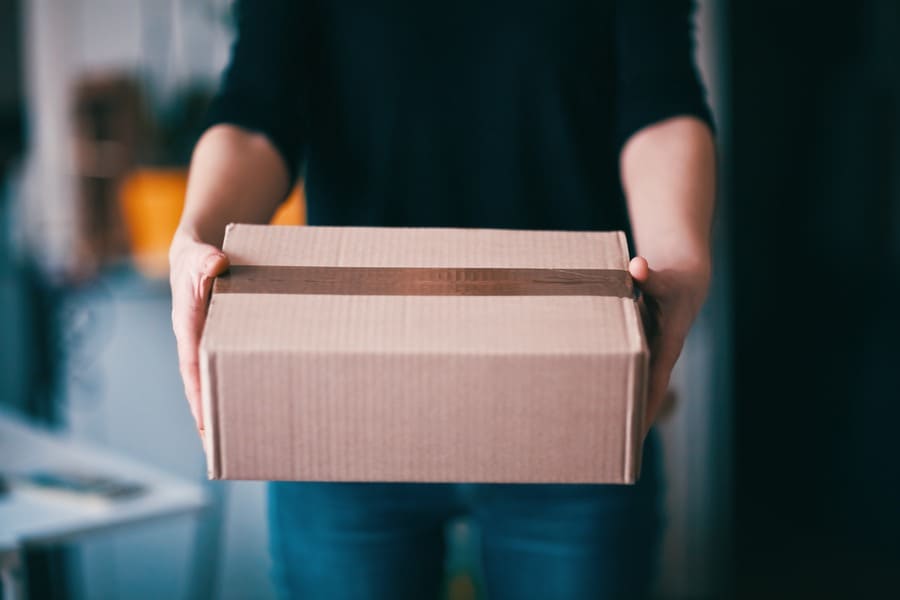 Stock photo, the delivery person giving a delivery box. 