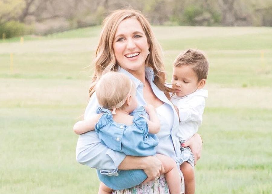 Katie, photographed holding Grayson and Hannah, in a park.