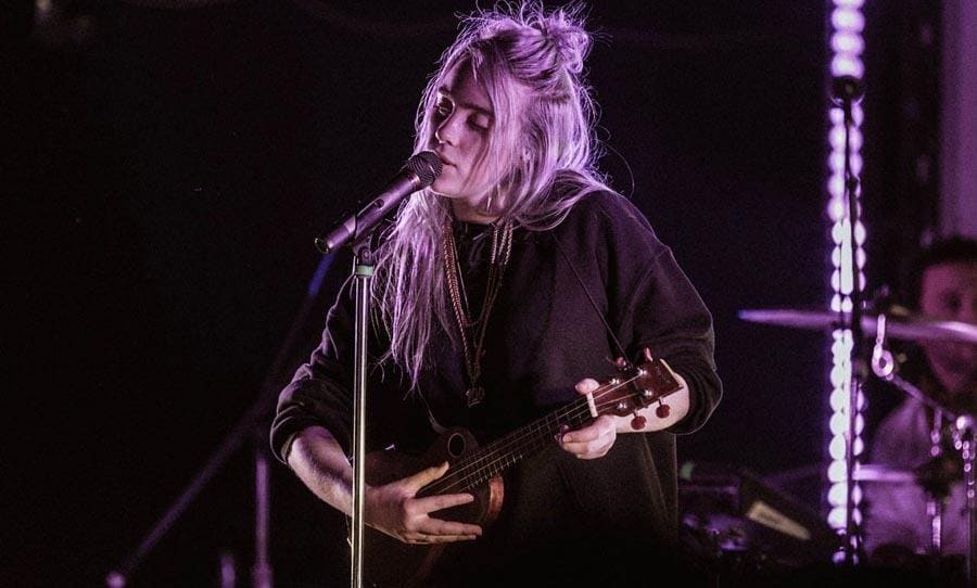 Billie Eilish is performing with her ukulele.