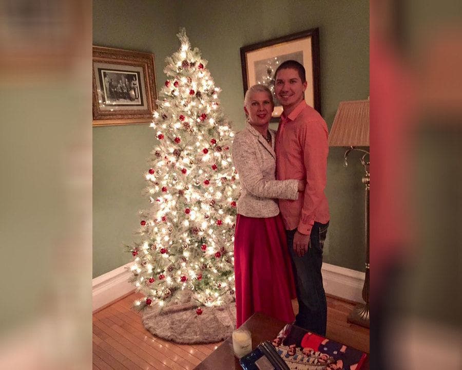 Henry Glendening and Kasey Bergh in front of a Christmas tree