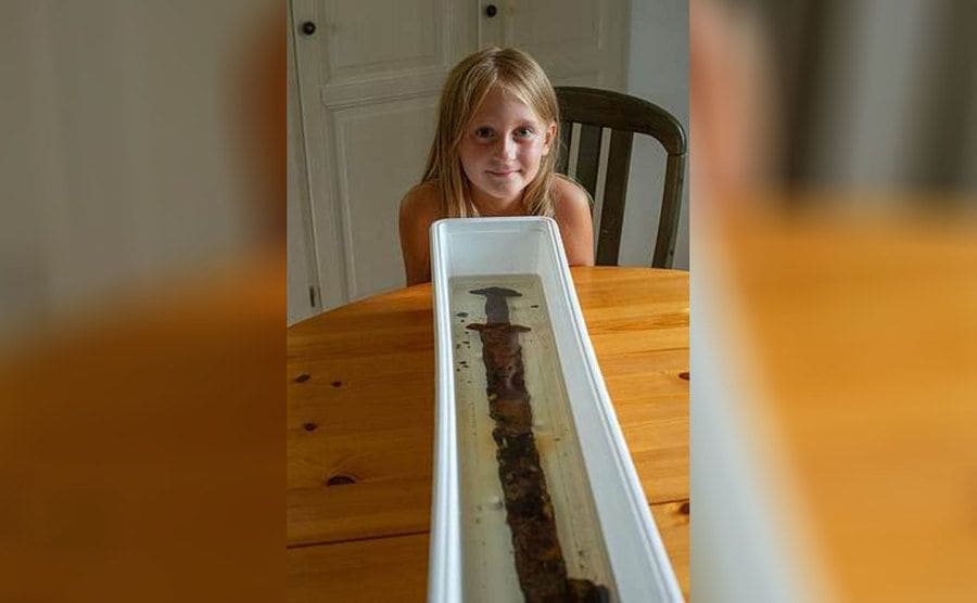 Saga Vanecek poses beside the ancient sword she pulled from a lake