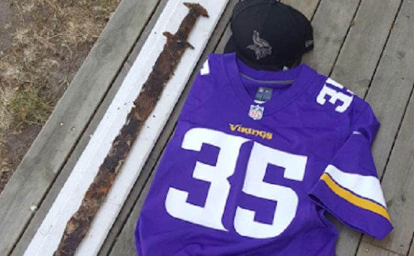 The ancient sword placed beside a Minnesota Vikings jersey