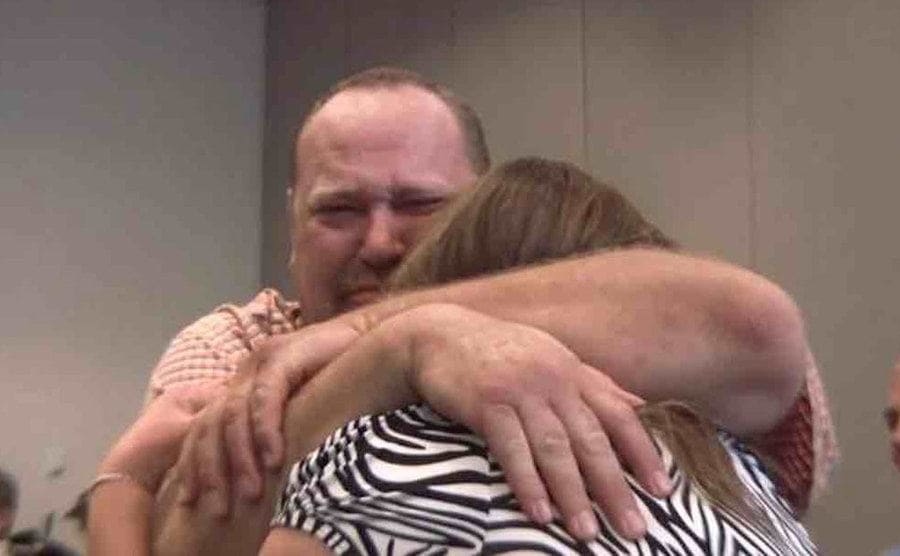 Loren Krytzer is hugging his wife. 